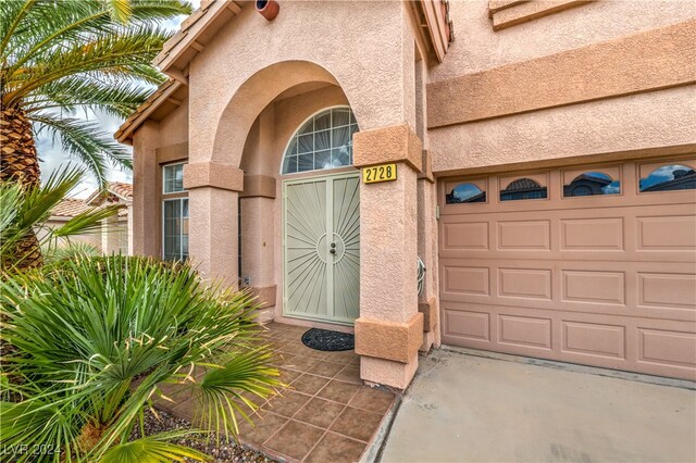 view of exterior entry featuring a garage