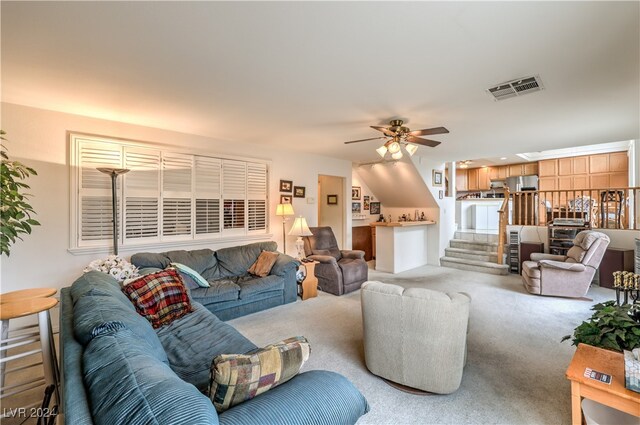 carpeted living room featuring ceiling fan