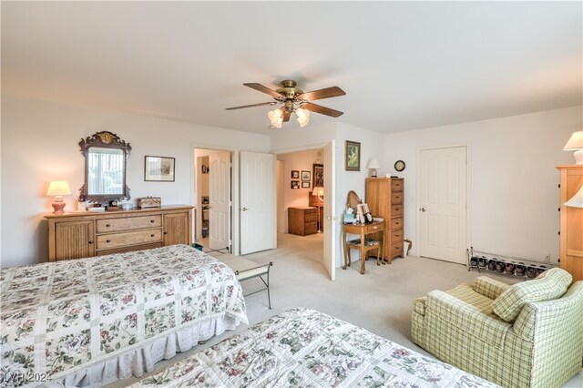 bedroom featuring light carpet and ceiling fan