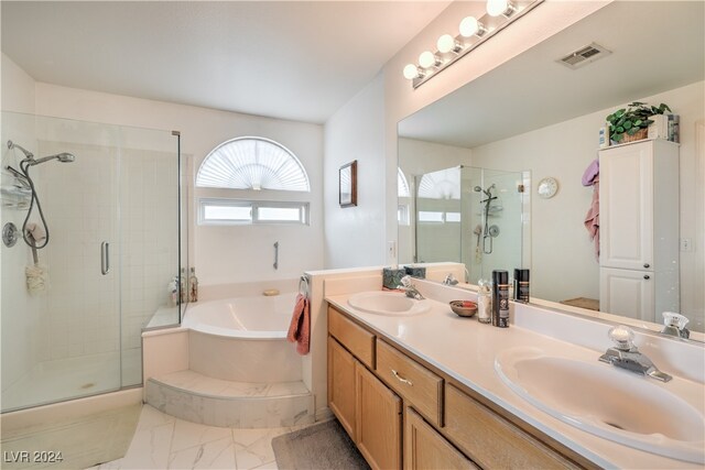 bathroom with independent shower and bath and vanity