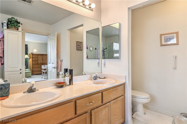 bathroom with tile patterned floors, vanity, and toilet