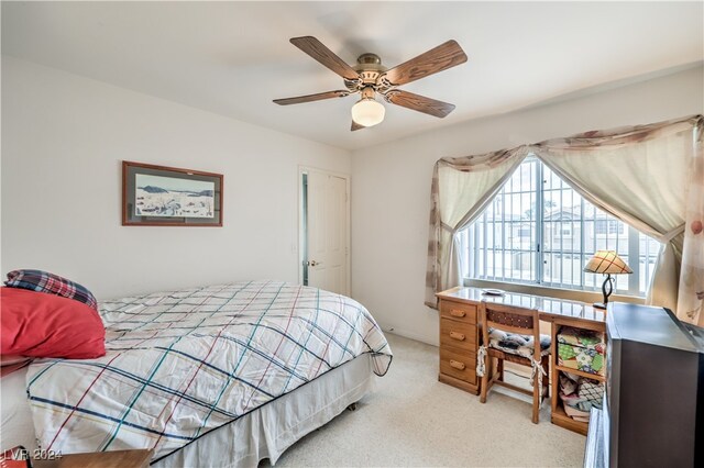 bedroom featuring light carpet and ceiling fan