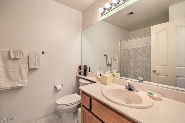 bathroom featuring vanity and toilet