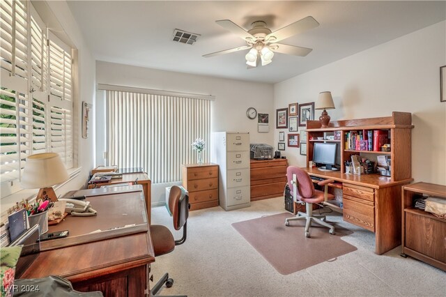 home office with light carpet and ceiling fan