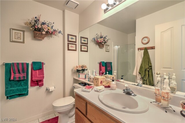 bathroom with walk in shower, vanity, tile patterned flooring, and toilet