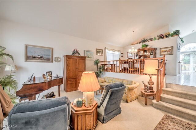 carpeted living room featuring lofted ceiling, a chandelier, and plenty of natural light