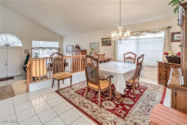 tiled dining area with an inviting chandelier and lofted ceiling