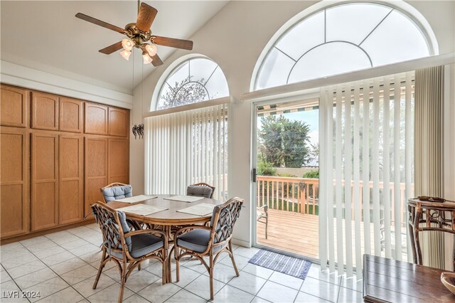 dining area featuring light tile patterned floors, vaulted ceiling, and ceiling fan