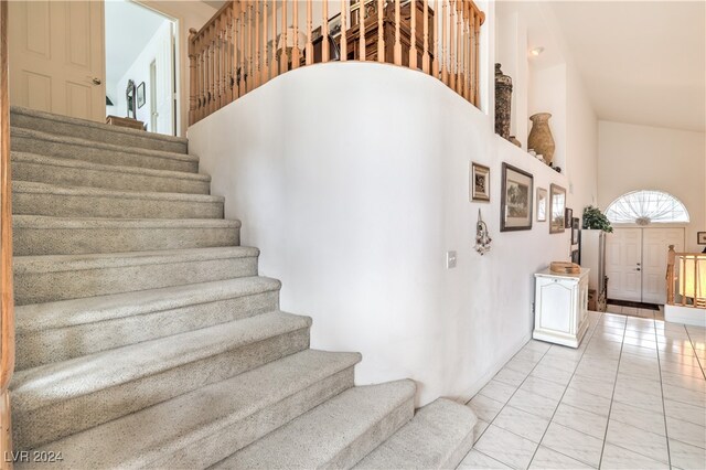 staircase featuring a high ceiling