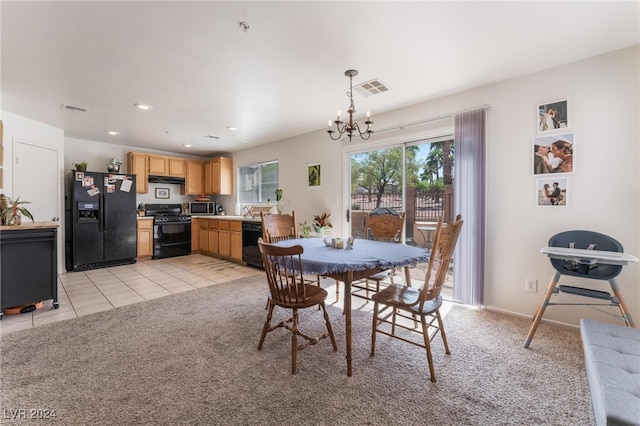 dining room with sink, a chandelier, and light colored carpet