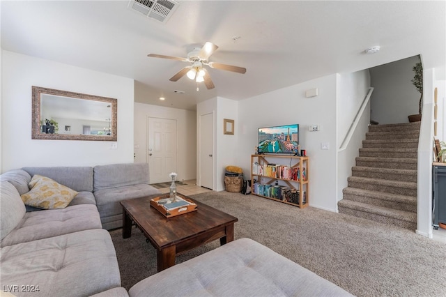 carpeted living room featuring ceiling fan