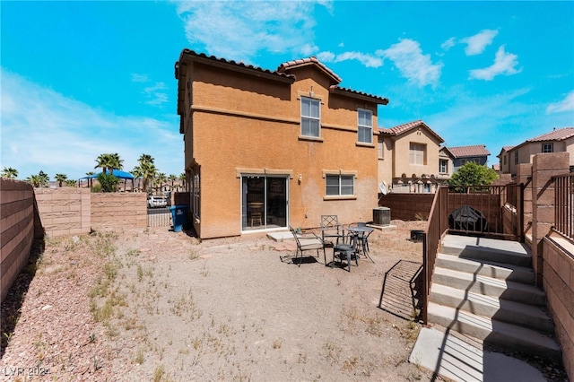 back of house with a patio and central AC