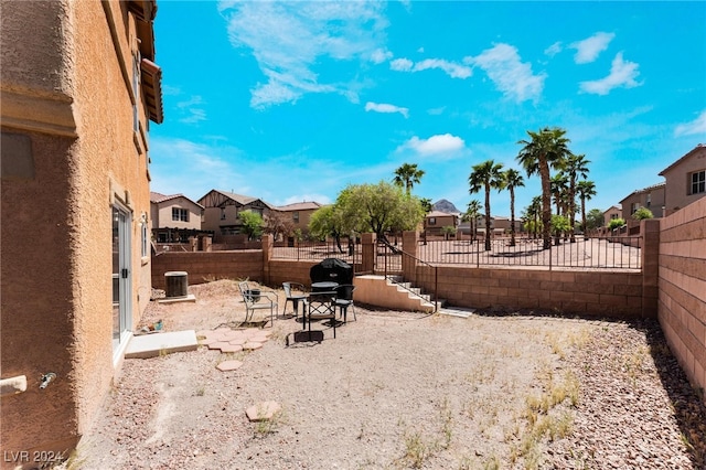 view of yard featuring a patio and central AC