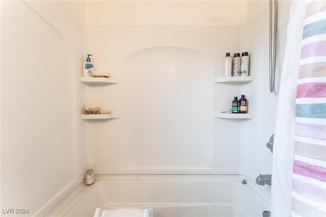 bathroom featuring shower / bathtub combination with curtain