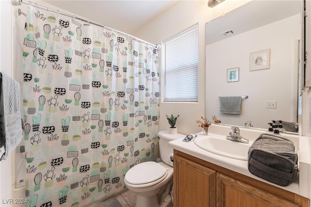 bathroom featuring a shower with curtain, vanity, toilet, and tile patterned floors