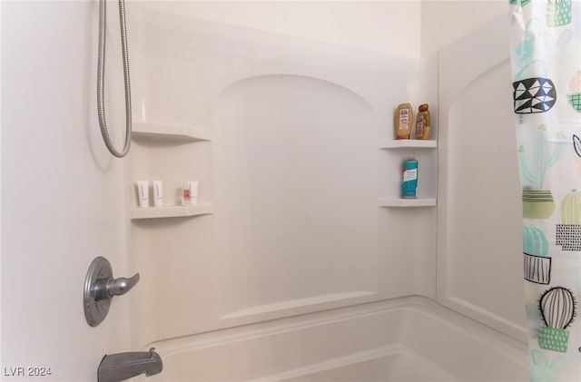 bathroom with shower / bath combination with curtain