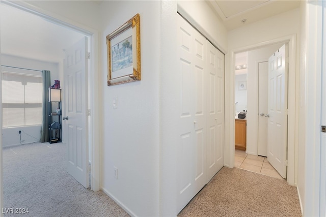 hallway featuring light colored carpet