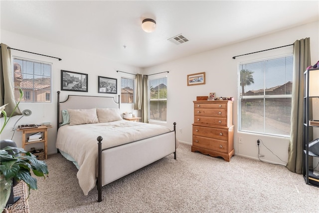 bedroom featuring light colored carpet