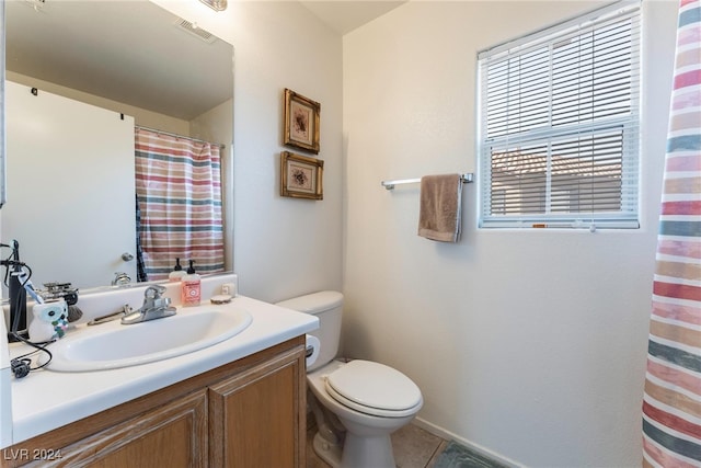 bathroom with a shower with curtain, vanity, tile patterned flooring, and toilet