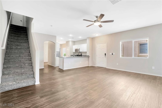 unfurnished living room with wood-type flooring and ceiling fan