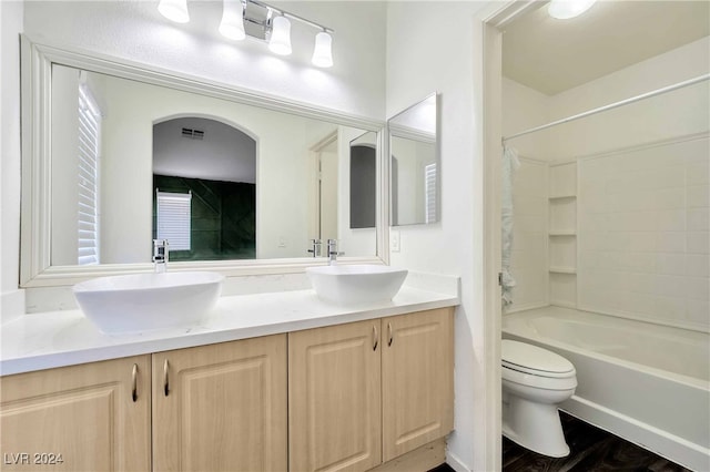 full bathroom with shower / bath combo, vanity, toilet, and hardwood / wood-style floors