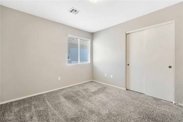 unfurnished bedroom with a closet and carpet floors