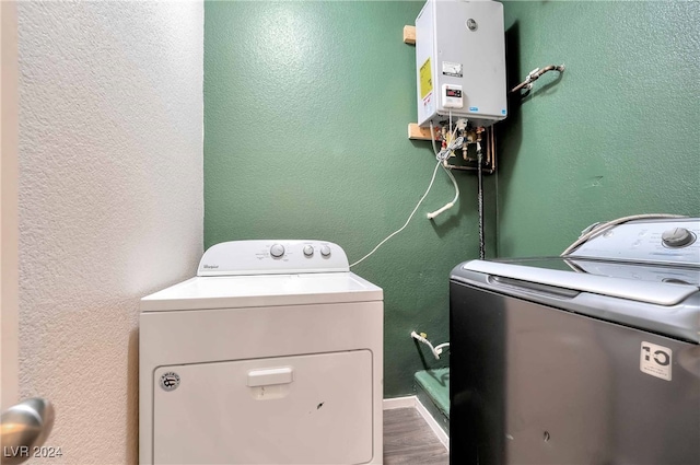 washroom featuring hardwood / wood-style flooring and washer and clothes dryer