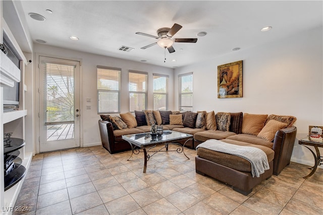 tiled living room with ceiling fan