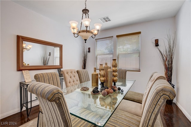 dining area featuring a chandelier and dark hardwood / wood-style flooring