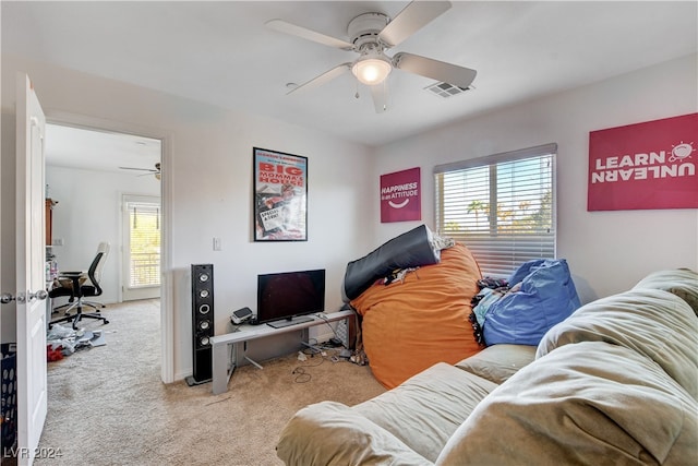 carpeted living room with ceiling fan and plenty of natural light