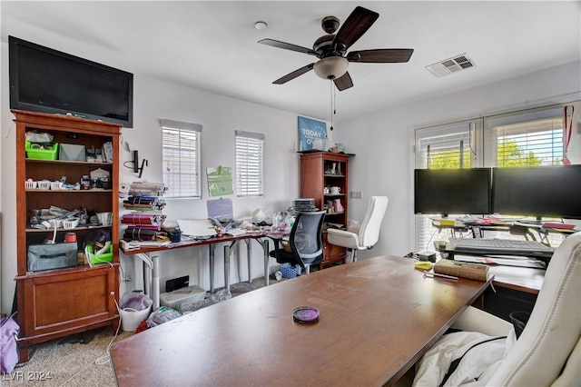 office area with ceiling fan and light carpet