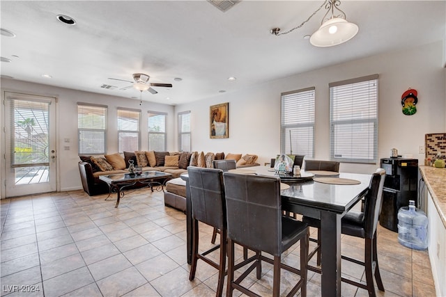 tiled dining area with ceiling fan and a wealth of natural light