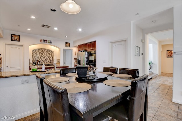 dining area with light tile patterned floors