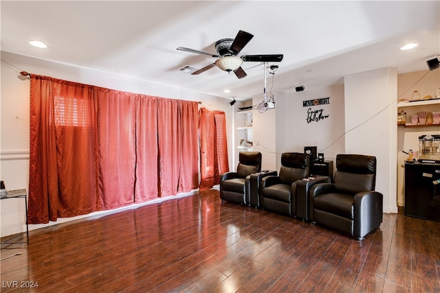 cinema featuring ceiling fan and dark wood-type flooring