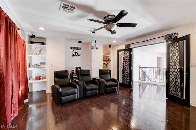 cinema with ceiling fan and dark hardwood / wood-style flooring