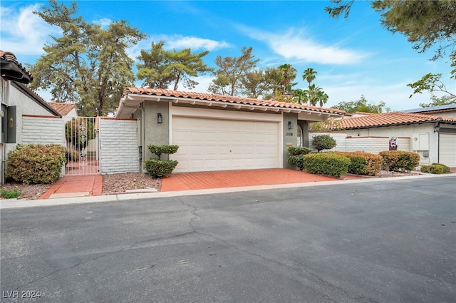 mediterranean / spanish home with a garage