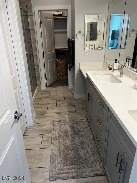 bathroom featuring walk in shower and vanity