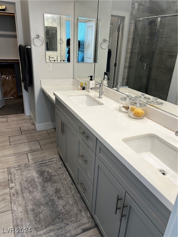 bathroom featuring walk in shower and vanity