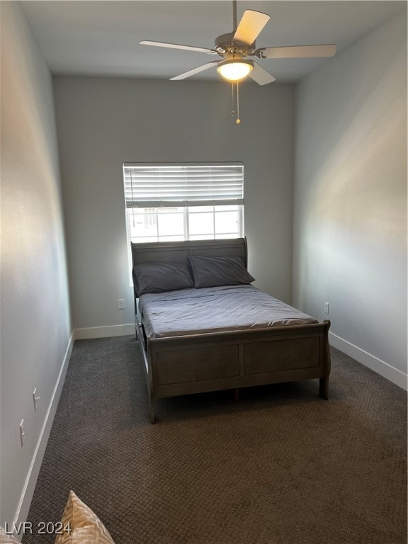 unfurnished bedroom with dark colored carpet and ceiling fan