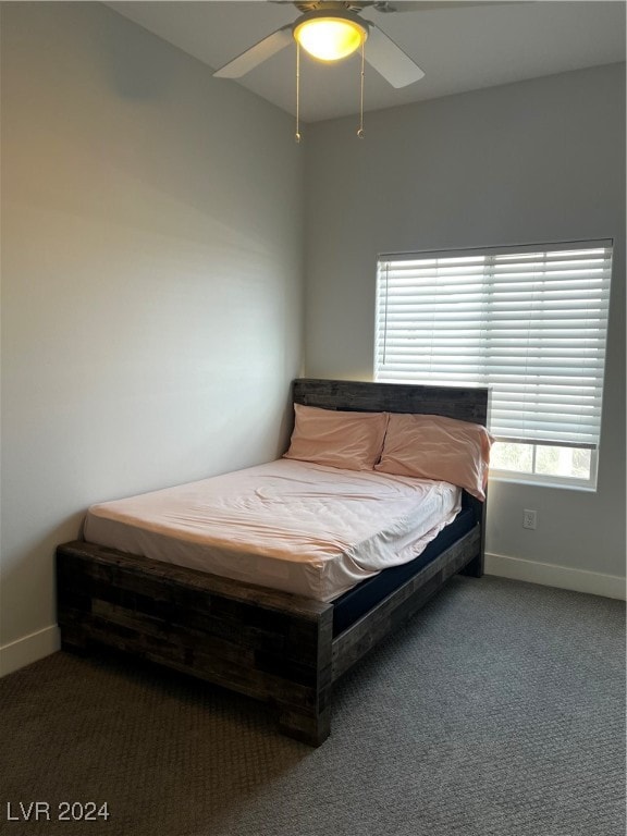 bedroom with dark carpet and ceiling fan