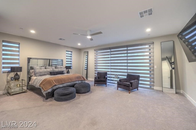 carpeted bedroom with multiple windows and ceiling fan