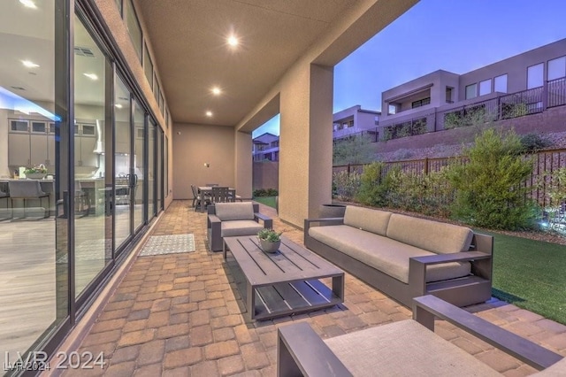 patio terrace at dusk featuring outdoor lounge area