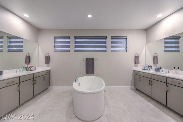 bathroom with vanity, a tub, and plenty of natural light