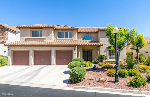 mediterranean / spanish-style home featuring a garage