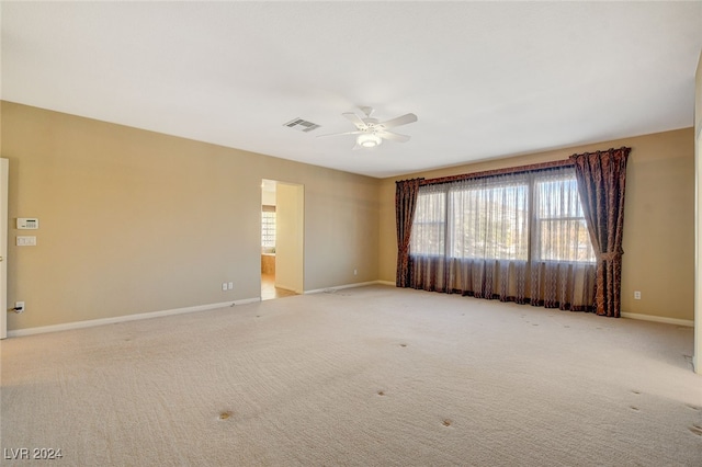 carpeted empty room with ceiling fan