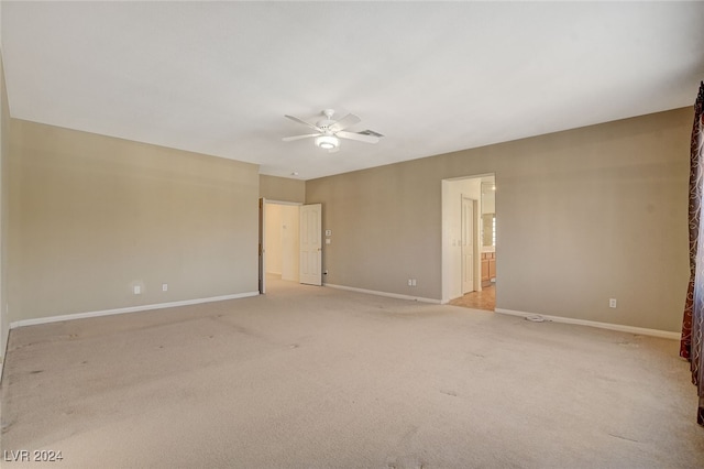 spare room featuring ceiling fan and light colored carpet