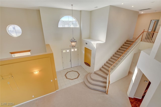 entryway featuring a towering ceiling