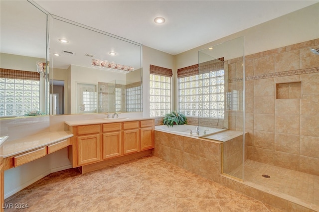 bathroom featuring a wealth of natural light, tile patterned flooring, vanity, and shower with separate bathtub