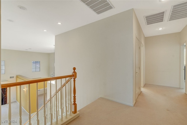 corridor with light colored carpet