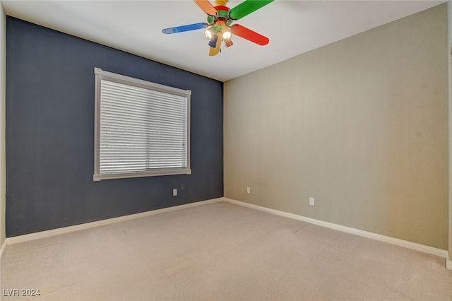 empty room with ceiling fan and light colored carpet